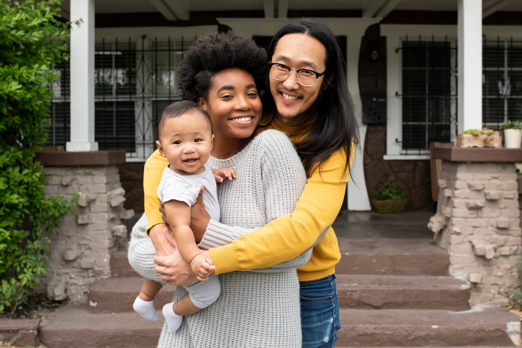 Diverse Couple with Child in Front of Home  Landscape  01